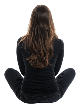 Woman in black seated cross-legged indoors, cut out - stock . png
