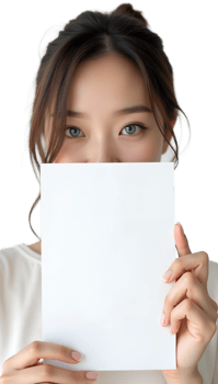 Woman holding a blank piece of paper in front of her face, playful expression on a black background. png