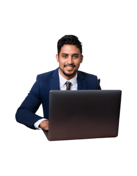 A man in a suit sitting at a desk with a laptop png