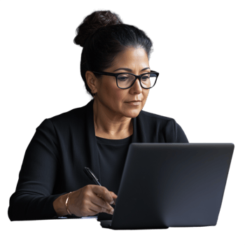 Confident woman wearing glasses working on a laptop, dressed in a business suit, on a transparent background png