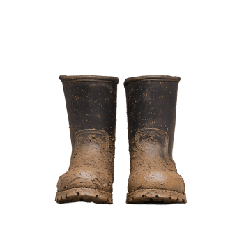 Pair of worn muddy boots on a transparent background symbolizing farm work and agriculture png