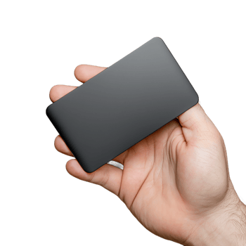 Hand holding a sleek rectangular black external hard drive png