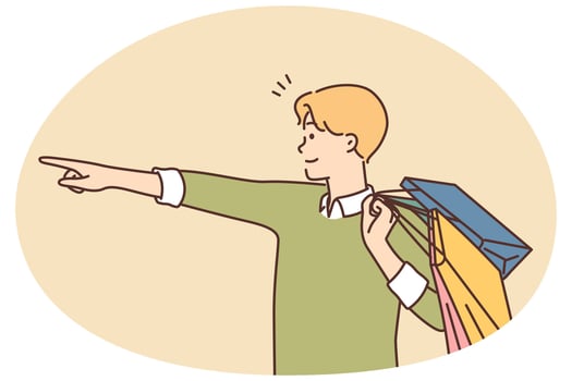 Happy man with shopping bags point with finger vector