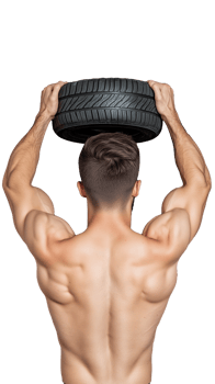 Muscular man lifting tire above his head and showing strength on transparent background png