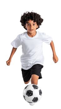 Child with curly hair playing soccer in white sportswear, running forward on transparent background png