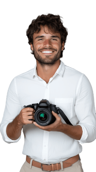 Smiling young man holding camera, dressed in white shirt on transparent background png
