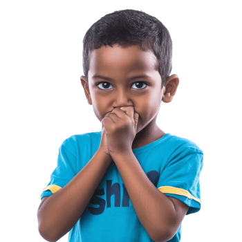 Young boy covering mouth with hands indoors png