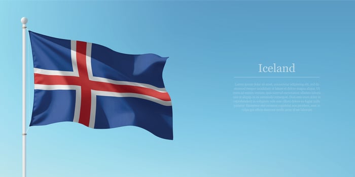 Waving Flag of Iceland Against Clear Blue Sky Copyspace vector