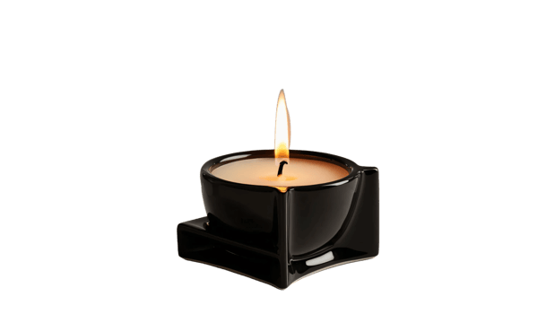 A lit candle placed inside a geometric black ceramic holder, featuring a modern and minimalist design. The flame emits a warm glow. Isolated on transparent background png