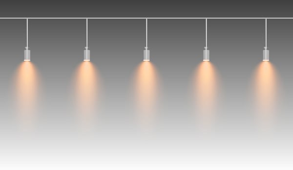 Row of yellow spotlights hanging from a track. Soft glow illuminating downward, creating a modern lighting effect. Ideal for stage lighting, exhibitions, and interior designs. Stage light vector