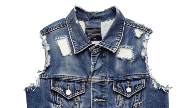 A denim vest with holes and torn edges png