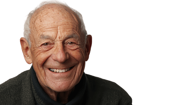 An older man smiling in front of a black background png