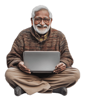 Elderly man smiling while using a laptop at home png