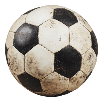 Worn soccer ball resting on a grassy field at dusk png