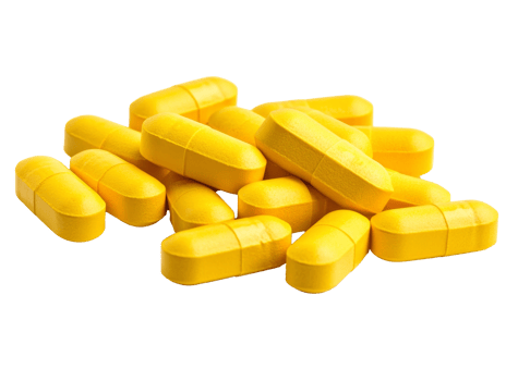 Yellow capsules on a white surface arranged neatly png