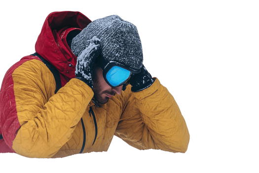 Man in yellow and red winter jacket with snow on hat and goggles on transparent background png