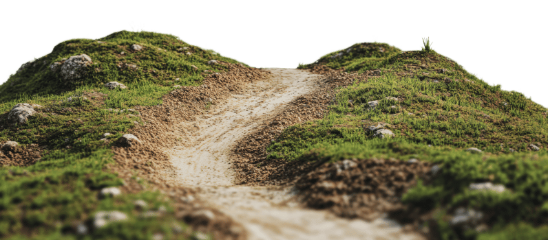 Winding dirt path through green hills at sunrise png