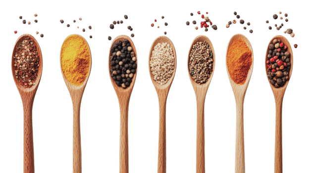 Variety of spices displayed in wooden spoons png