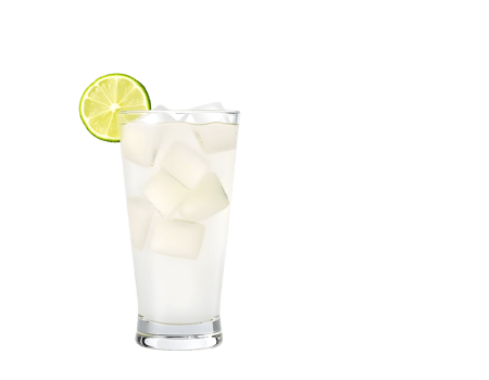 A glass of white drink with lime on top png