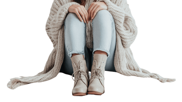 A fashionable girl dressed in a stylish layered cardigan paired with trendy ankle boots, perfect for a casual outing or a chic street style look.. png