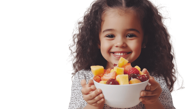 A Joyful Scene of a Young Girl Enjoying a Colorful Bowl of Fresh Fruit Salad, Perfect for Promoting Healthy Eating Habits and Family Meals. png