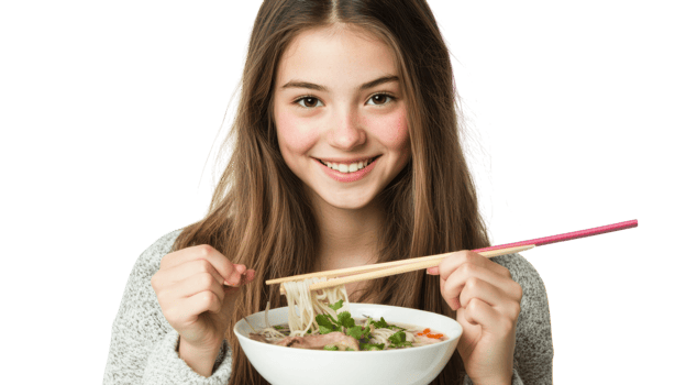 A young woman savoring a delightful bowl of pho in a cozy setting, perfect for food blogs, restaurant menus, and culinary advertisements showcasing Vietnamese cuisine.. png