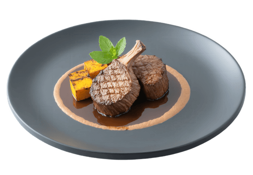 Mocha mousse-spiced lamb chops with a coffee-infused marinade, served with couscous and roasted vegetables. The lamb chops are grilled png