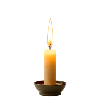 A single candle is lit in a small bowl png