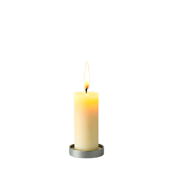 A single candle is lit on a black background png