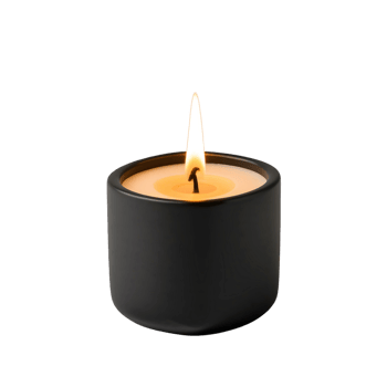 A candle is lit in a black container png