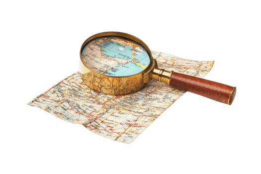 A magnifying glass rests on a folded map, emphasizing details and locations within the cartographic representation. png
