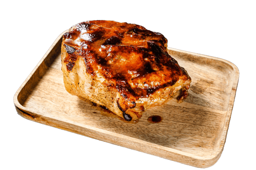 Roasted pork neck with spices on cutting board. Black background. Top view png