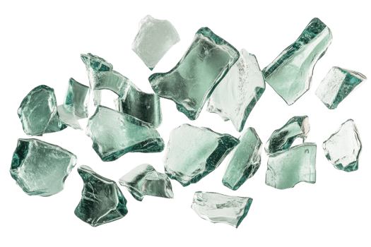 Fragments of clear glass scattered across a white surface showcasing various shapes and sizes with smooth edges and reflective surfaces png