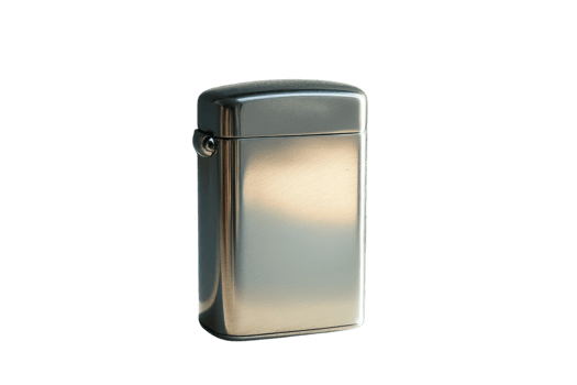 Classic metal lighter sitting on a smooth surface reflecting warm light in a minimalist setting png