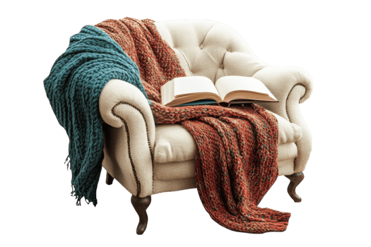 Cozy armchair adorned with warm blankets and a book invites relaxation in a tranquil setting png