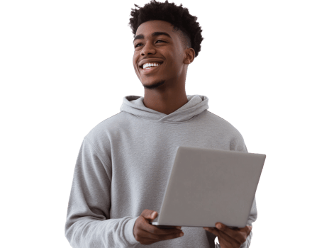 Young man smiling while holding a laptop indoors png