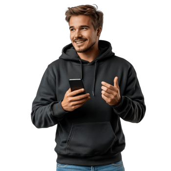 Young man in a hoodie smiles while using his smartphone indoors during daylight hours png