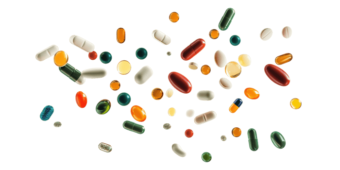 Assorted colorful pills and capsules floating isolated on transparent background png