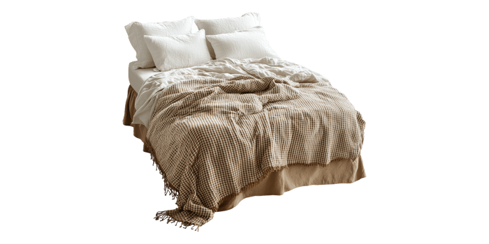 Cozy bed with checkered blanket and pillows isolated on transparent background png