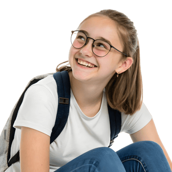 Teen girl with glasses smiles warmly while sitting on the floor during a candid moment in a bright setting png