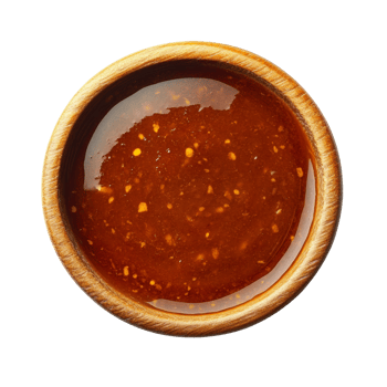 Spicy orange sauce in a wooden bowl png