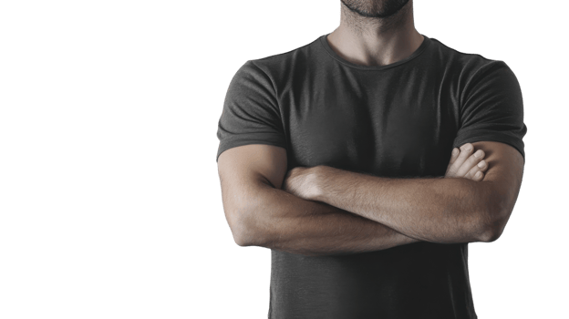 Man with crossed arms standing confidently in casual attire against a plain white background, showcasing a relaxed yet determined demeanor png