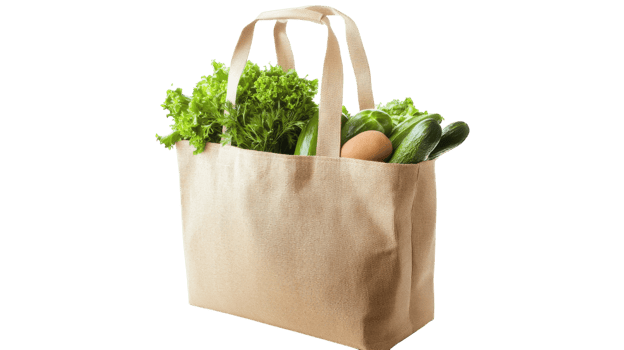 Fresh vegetables and eggs in a reusable shopping bag from a local market during a sunny afternoon png