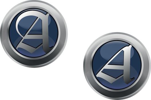 Two metal badges with the letter a on them vector