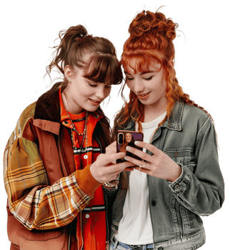 two young women are looking at their cell phones png