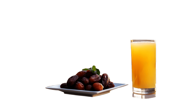 A glass of orange juice next to a plate of dates png