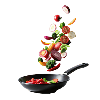 Vibrant Vegetables Falling into a Black Frying Pan A Culinary Delight png