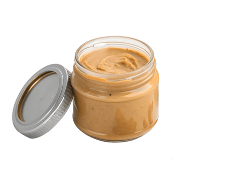Delicious creamy nut butter in glass jar png