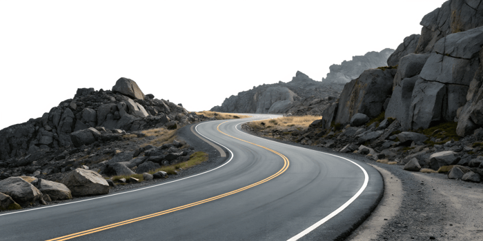 Winding road through rocky landscape in daylight png
