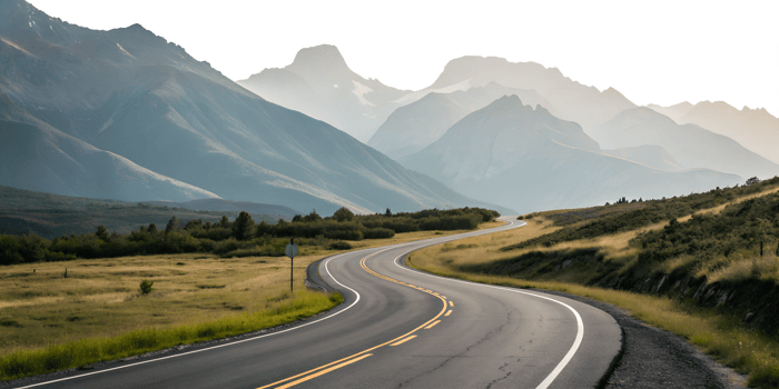Scenic winding road through mountain landscape png